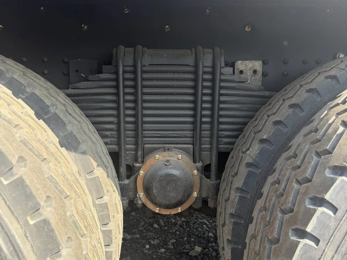 SHACMAN X3000 dump truck — side view at a sourcing yard